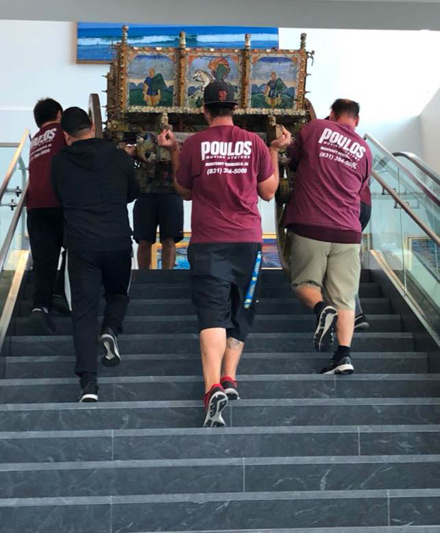 Poulos Moving guys moving item up stairs