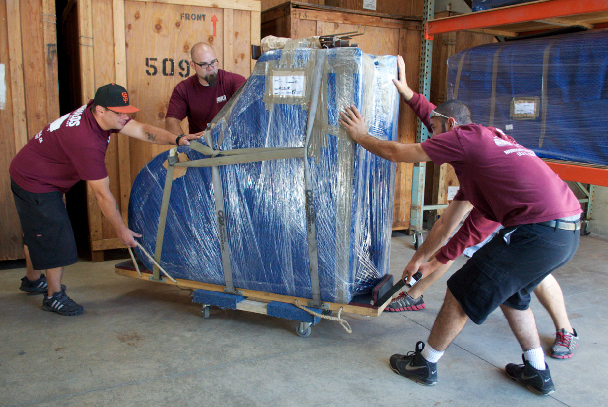 Poulos Guys moving a piano